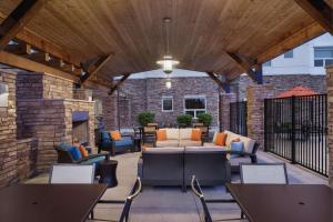 an outdoor patio with furniture and a brick wall at Hyatt House Boulder/Broomfield in Broomfield