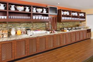 a kitchen with a counter with bowls and vases at Hyatt House Dallas Las Colinas in Irving