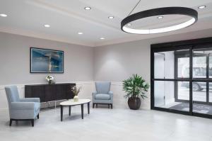 a waiting room with two chairs and a tv at Hyatt House White Plains in White Plains