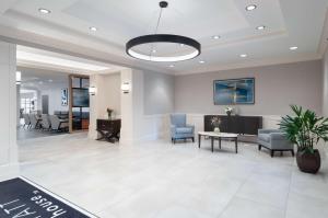 a lobby of a hospital with chairs and a table at Hyatt House White Plains in White Plains