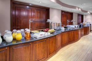 a buffet line in a room with wood paneling at Hyatt House Parsippany East in Parsippany