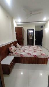 a bedroom with a large bed in a room at Park facing flat for yr comfort in Indore