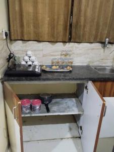 a small kitchen with a counter and a sink at Park facing flat for yr comfort in Indore