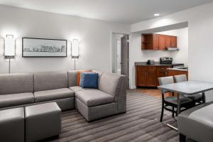 a living room with a couch and a kitchen at Hyatt House Scottsdale Old Town in Scottsdale