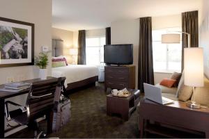 a hotel room with a bed and a desk at Hyatt House Philadelphia-King of Prussia in King of Prussia