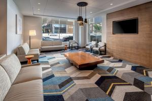 a lobby with couches and a tv and a coffee table at Hyatt House Salt Lake City Downtown in Salt Lake City