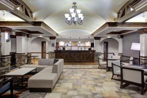 a lobby with a waiting room with a couch and chairs at Hyatt House Fishkill-Poughkeepsie in Fishkill