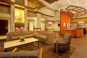 a lobby with a couch and a table and chairs at Hyatt Place Atlanta Airport North in Atlanta