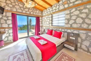 a bedroom with a large bed with red pillows at Luxury and Cosy villas in Kas +64 photos