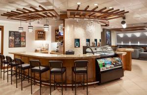 a bar in a restaurant with bar stools at Hyatt Place Atlanta/Cobb Galleria in Atlanta