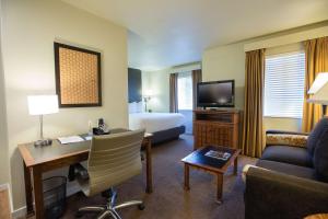 a hotel room with a bed and a desk and a room at Hyatt House San Ramon in San Ramon