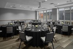 una sala de conferencias con mesas y sillas. en Hyatt House Raleigh North Hills, en Raleigh