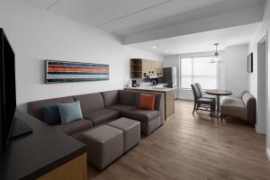 a living room with a couch and a table at Hyatt House Raleigh North Hills in Raleigh