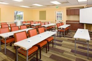 a classroom with tables and chairs and a screen at Hyatt House Belmont Redwood Shores in Belmont