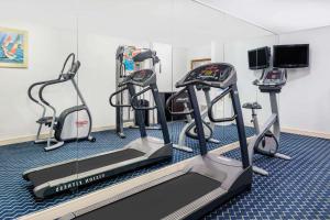 a gym with three tread machines and a treadmill at Baymont by Wyndham Savannah Midtown in Savannah