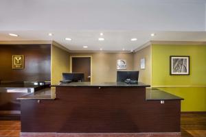 a hotel lobby with a reception desk and yellow walls at Sleep Inn & Suites in Colby
