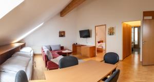 a living room with a couch and a table at Hotel Löwen in Lingenau