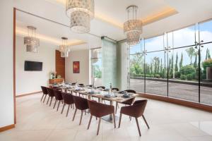 a large dining room with a long table and chairs at Hyatt Place Hyderabad Banjara Hills in Hyderabad