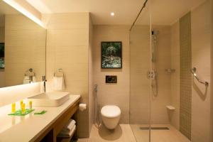 a bathroom with a shower and a toilet and a sink at Hyatt Place Hyderabad Banjara Hills in Hyderabad