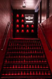 a staircase with red lights in a building at Hyatt Place Hyderabad Banjara Hills in Hyderabad