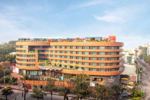 a large building with buses on top of it at Hyatt Place Hyderabad Banjara Hills in Hyderabad