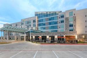 a large building with a parking lot in front of it at Hyatt Place Austin Cedar Park in Cedar Park