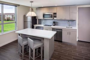 a kitchen with a large white island in a room at Hyatt House Charleston/Mount Pleasant in Charleston