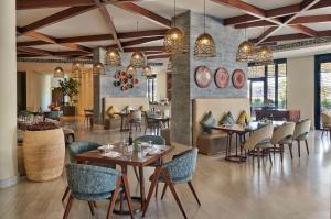 a restaurant with tables and chairs in a room at Hyatt Regency Addis Ababa in Addis Ababa