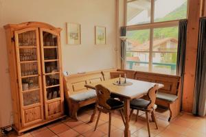 a dining room with a table and chairs and a window at Bergblick am Kaminfeuer in Aschau im Chiemgau