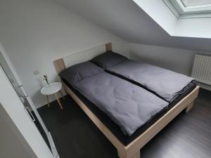 a bedroom with a bed in a small room at Ruhige Ferienwohnung auf dem Land in Starzach