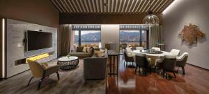 a living room with a table and chairs and a tv at Hyatt Regency Beijing Shiyuan in Yanqing