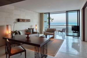 a living room with a couch and a tv at Alila Seminyak in Seminyak