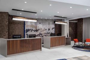 an office lobby with a reception desk and chairs at Hyatt Place New York City/Times Square in New York