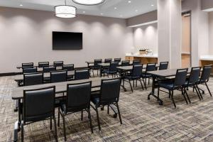 a conference room with tables and chairs and a tv at Hyatt House Nashville Downtown-Convention Center in Nashville
