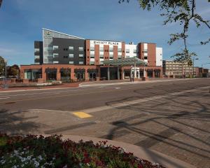 an empty street in front of a large building at Hyatt Place Moncton-Downtown in Moncton
