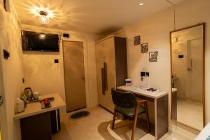 a small room with a desk and a chair at Click Hotel Mundra in Mundra