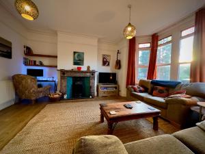 a living room with a couch and a coffee table at Victorian Cottage Like Charm with Modern Comforts in Bristol