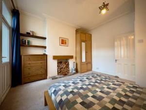 a bedroom with a bed and a fireplace at Victorian Cottage Like Charm with Modern Comforts in Bristol