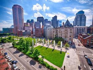a city with a park in the middle of a street at Hyatt Place Boston/Seaport District in Boston +78 photos