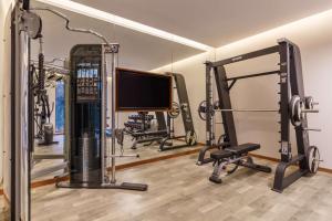 a gym with treadmills and a flat screen tv at Hyatt Place Kathmandu in Kathmandu