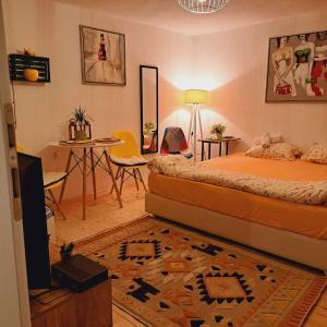 a bedroom with two beds and a room with a table at Hello Skopje! in Skopje +30 photos