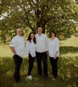 a family posing for a picture in front of a tree at Hotel Gasthof Zur Post in Königstein in der Oberpfalz