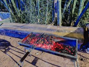 a barbecue grill sitting on top of a bench at Verdant Hillock in Wayanad