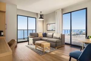 a living room with a couch and a table at Hyatt Place Virginia Beach Oceanfront in Virginia Beach