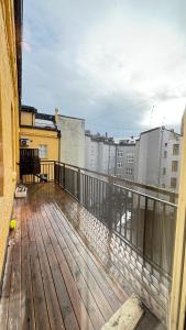 a balcony with a wooden deck with buildings at Oslo-Frogner in Oslo