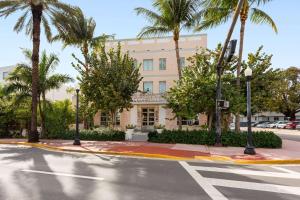 a building with palm trees in front of a street at The Astor by LuxUrban, Trademark Collection by Wyndham in Miami Beach