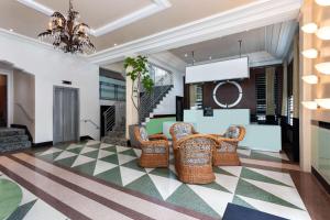 a lobby with wicker chairs and a table at The Astor by LuxUrban, Trademark Collection by Wyndham in Miami Beach