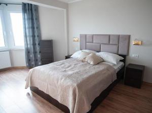 Кровать или кровати в номере ARAVELL E17 Darłówko Wschodnie