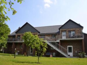 a large brick house with a staircase on it at Holiday apartment Villa Sonja in Zützen