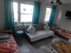 a living room with a couch and a table at Apartament obok Zamku in Malbork